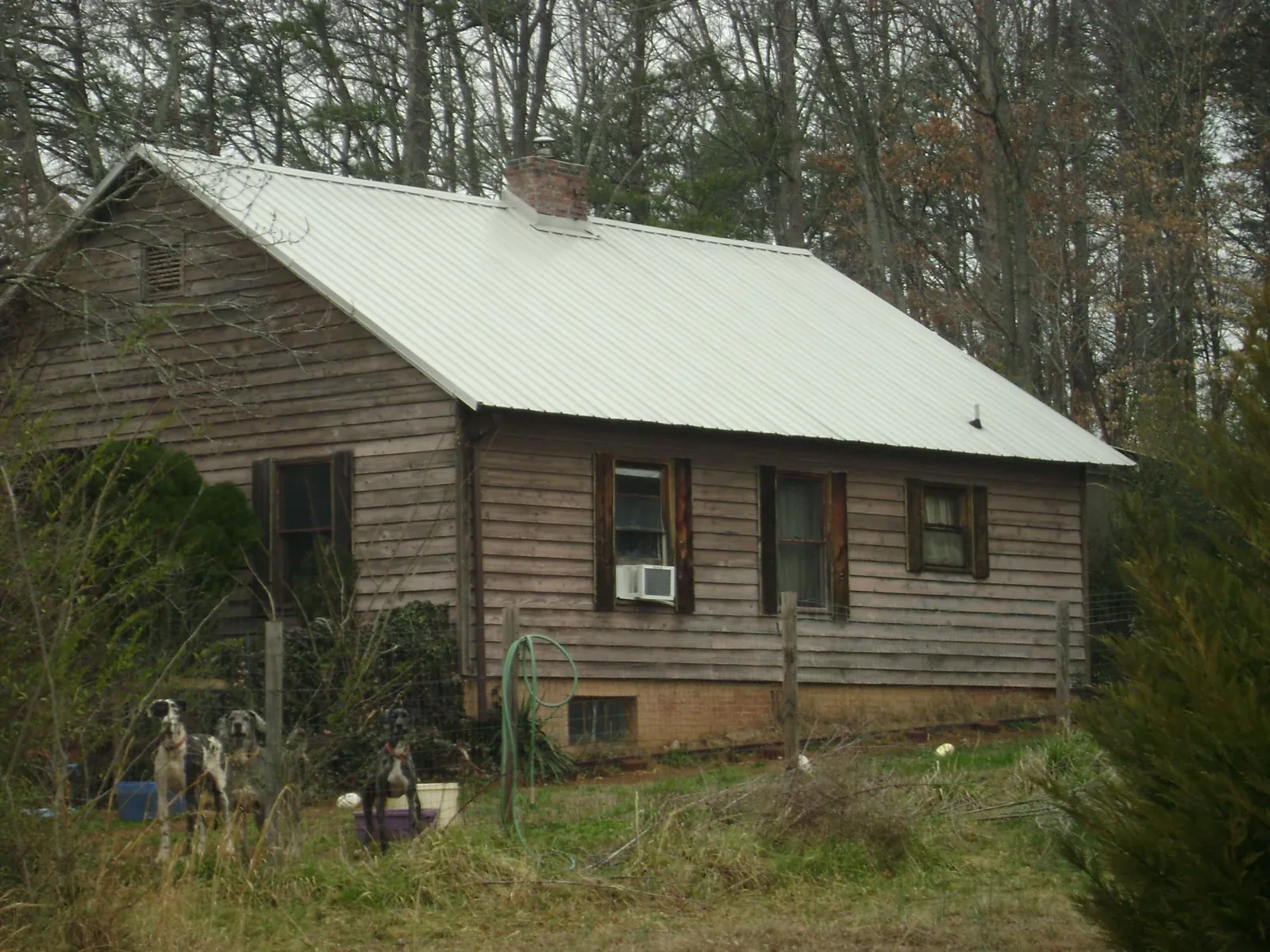 White metal roof on an old wood sided farmhouse, from a Metal Roof Installation job in Goldvein